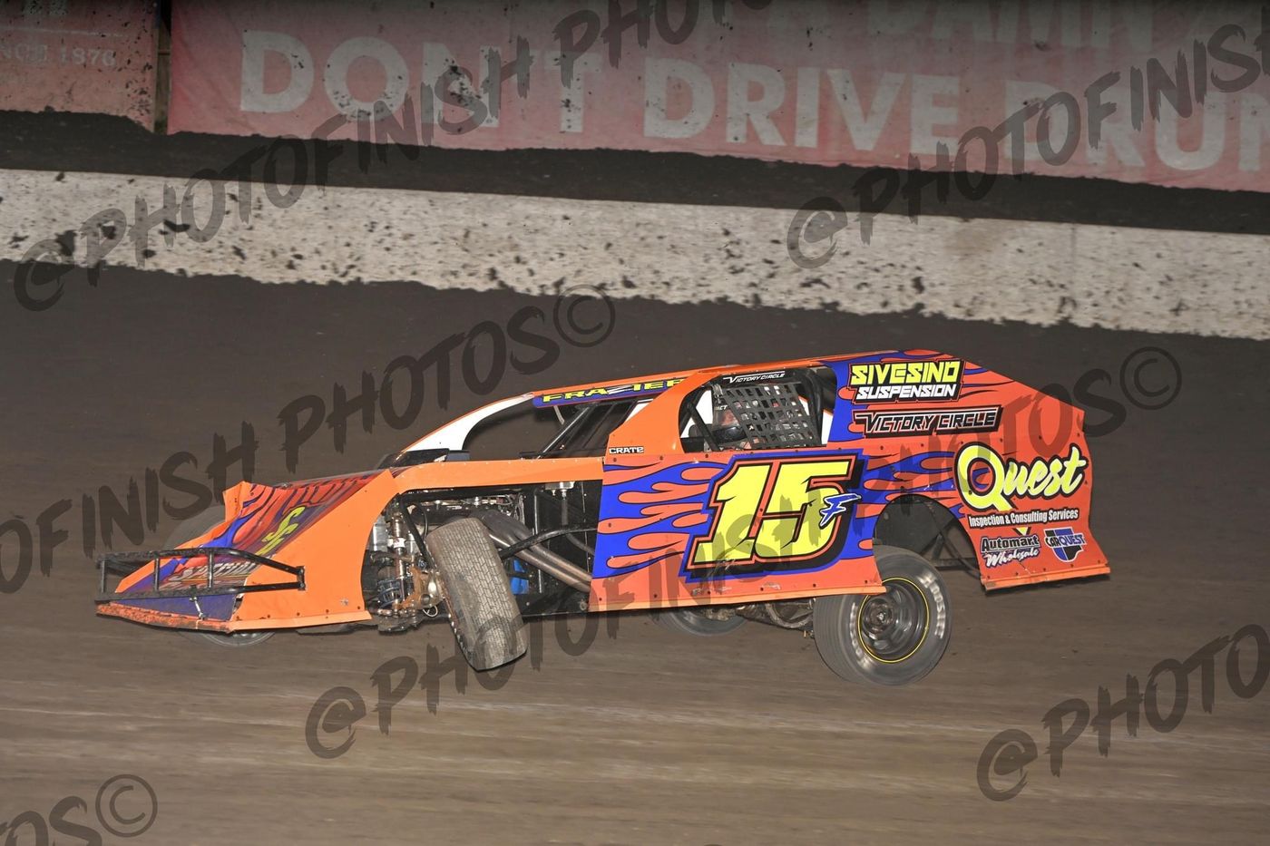 Markus Frazier #15F orange IMCA Modified at speed — night racing